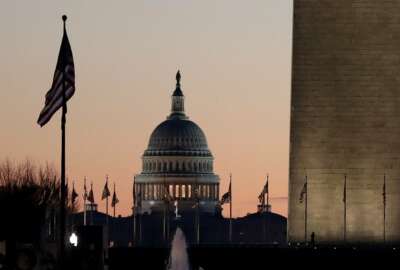 The U.S. Capitol building, center, and part of the Washington Monument, right, are seen at sunrise, Wednesday, Dec. 18, 2019, on Capitol Hill in Washington. President Donald Trump is on the cusp of being impeached by the House, with a historic debate set Wednesday on charges that he abused his power and obstructed Congress ahead of votes that will leave a defining mark on his tenure at the White House. (AP Photo/Julio Cortez)