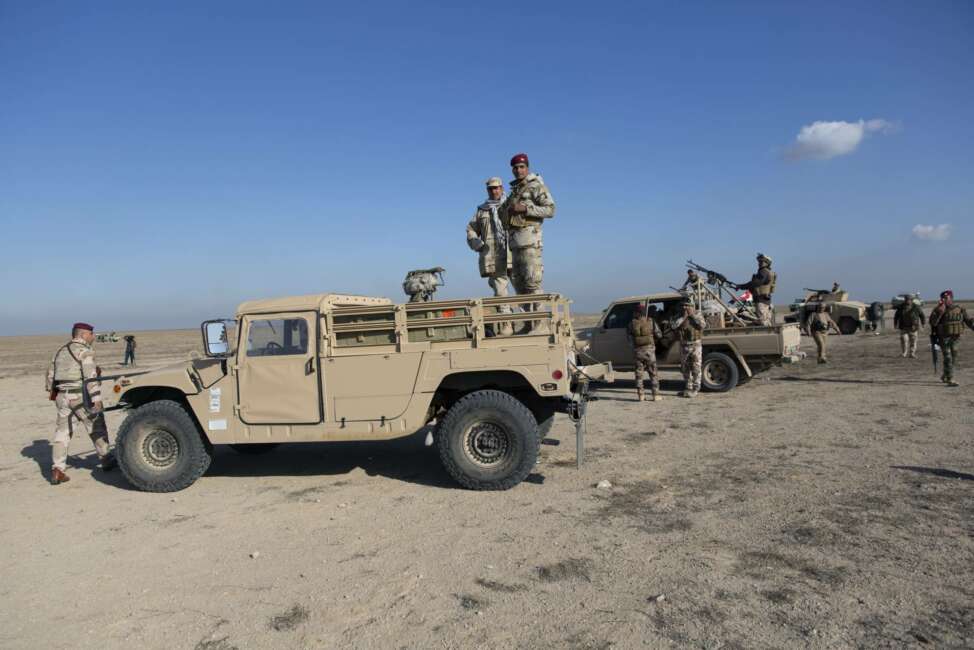 Iraqi army units are deployed during military operations of the Iraqi Army's Seventh Brigade in Anbar, Iraq, Sunday, Dec. 29, 2019. An Iraqi general said Sunday that security has been beefed up around the Ain al-Asad air base, a sprawling complex in the western Anbar desert that hosts U.S. forces, following a series of attacks. (AP Photo/Nasser Nasser)