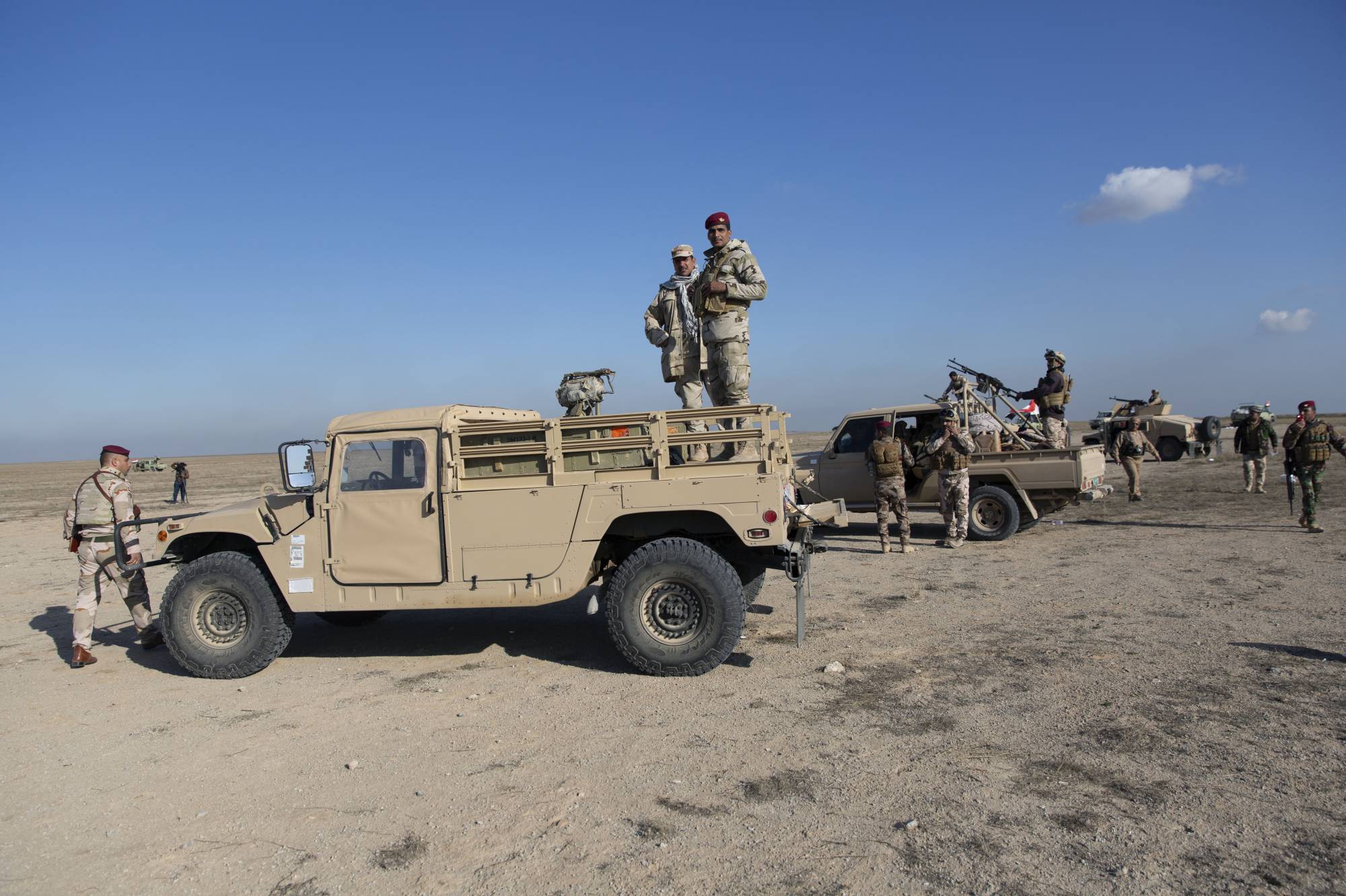 Iraqi army units are deployed during military operations of the Iraqi Army's Seventh Brigade in Anbar, Iraq, Sunday, Dec. 29, 2019. An Iraqi general said Sunday that security has been beefed up around the Ain al-Asad air base, a sprawling complex in the western Anbar desert that hosts U.S. forces, following a series of attacks. (AP Photo/Nasser Nasser)
