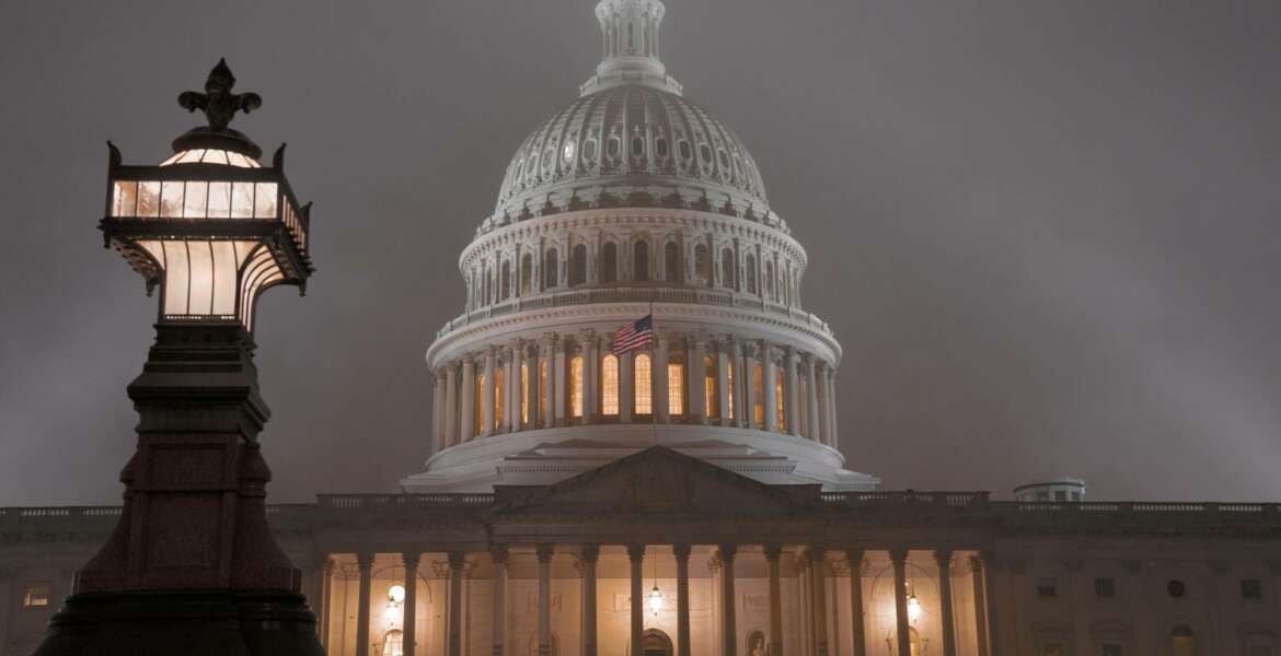 The U.S. Capitol in Washington is shrouded in mist, Friday night, Dec. 13, 2019.  This coming week’s virtually certain House impeachment of President Donald Trump will underscore how Democrats and Republicans have morphed into fiercely divided camps since lawmakers impeached President Bill Clinton.(AP Photo/J. Scott Applewhite)