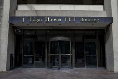FILE - In this March 4, 2019, file photo, the J. Edgar Hoover FBI Building is seen in Washington. The FBI, in a change of policy, is committing to inform state officials if local election systems have been breached, federal officials told The Associated Press. (AP Photo/Alex Brandon, File)