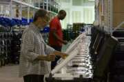 FILE - In this Sept. 22, 2016, file photo, employees of the Fulton County Election Preparation Center in Atlanta test electronic voting machines. A computer security expert says he found that an election server central to a legal battle over the integrity of Georgia elections showed signs of tampering. The server was left exposed to the open internet for at least six months, a problem discovered in August 2016. (AP Photo/Alex Sanz, File)