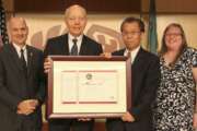 Jian Wang, second from right, receives an award from 