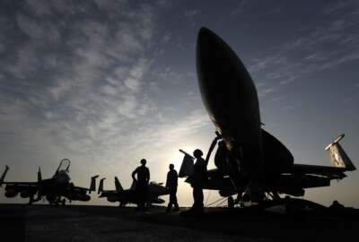 FILE- In this Nov. 22, 2016 file photo, U.S. Navy sailors stand by fighter jets on the deck of the U.S.S. Dwight D. Eisenhower in the Persian Gulf. The United States’ Gulf allies have pushed for hawkish policies by Washington to pressure, isolate and cripple Iran, but this high-stakes strategy is now being put to the test by the surprise U.S. killing of Iran’s most powerful military commander. The killing appears to have caught America's Gulf allies off-guard and threatens to draw Gulf states further into the cross-hairs of rising tensions between Washington and Tehran. (AP Photo/Petr David Josek, File)