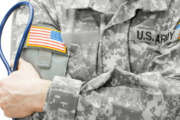 US Army doctor holding stethoscope - studio shot