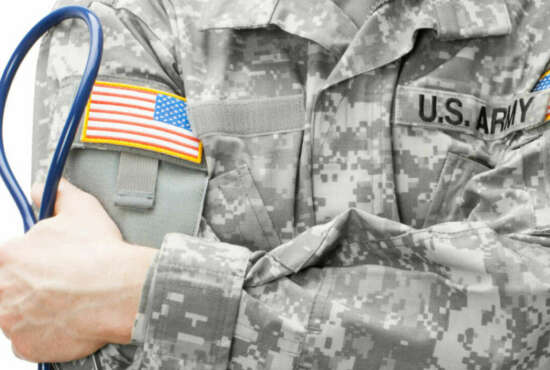 US Army doctor holding stethoscope - studio shot