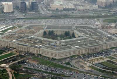 FILE - This March 27, 2008, aerial file photo, shows the Pentagon in Washington. A Federal court has ordered the Pentagon to temporarily halt work with Microsoft on its $10 billion military cloud contract, Thursday, Feb. 13, 2020, after Amazon sued alleging that President Donald Trump's bias against the company hurt its chances to win the project.  Amazon requested the court issue the injunction last month. Both the documents requesting the block and the judge's decision to issue the temporary injunction are sealed by the court.   (AP Photo/Charles Dharapak, File)