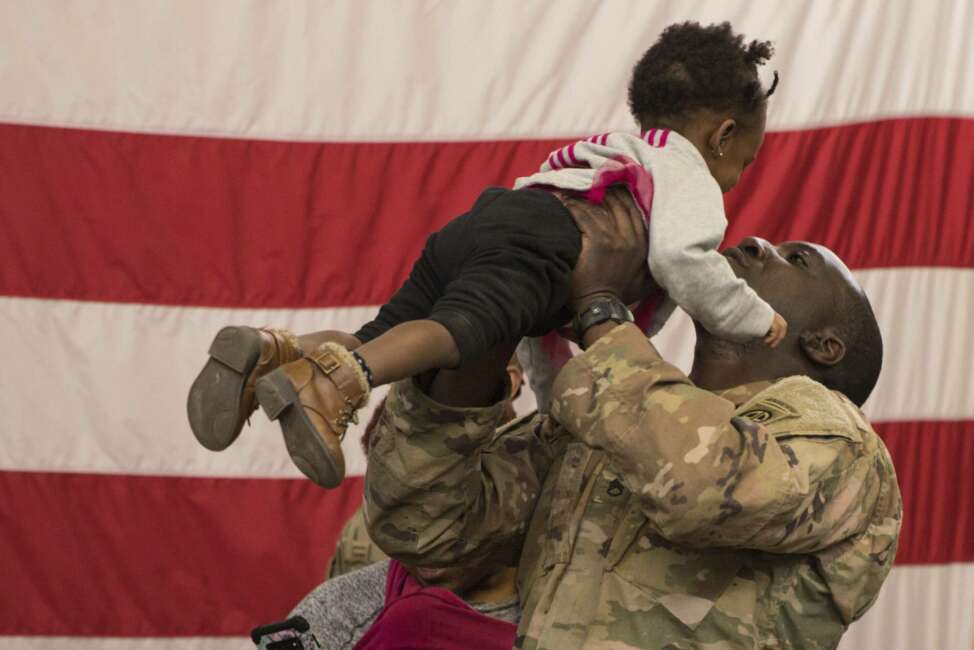 A soldier reunites with his daughter at Fort Bragg, N.C.  after returning from the Middle East. The 82nd Airborne Division's Immediate Response Force had been deployed since New Years Eve. Thursday, Feb. 20, 2020. Nearly two months after a U.S. Army rapid-response force was activated amid tensions with Iran, deploying 3,000 soldiers to the Middle East, some are returning home. By the end of the weekend, nearly 800 paratroopers from the 82nd Airborne Division’s Immediate Response Force are slated to have returned to Fort Bragg, North Carolina. On Thursday morning, eager family members waited in the base’s iconic Green Ramp to greet their loved ones. (U.S. Army via AP)