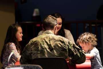 Senior Master Sgt. Paul Kalle, 723d Aircraft Maintenance Squadron first sergeant, speaks with a family during a Deployed Spouses Dinner Feb. 18, 2020, at Moody Air Force Base, Georgia. The monthly event is a free dinner at Georgia Pines Dining Facility designed as a ‘thank you’ for each families’ support and sacrifice while their spouse is deployed or on a remote assignment. The dinner, occurring on every third Tuesday of the month, provides an opportunity for spouses to interact with other families of deployed Airmen, key spouses and unit leadership, as well as provide a break for the spouse while military sponsor is deployed. The next Deployed Spouses Dinner will be March 17. (U.S. Air Force photo by Senior Airman Erick Requadt) 