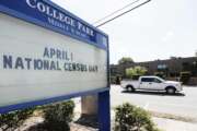 In this Tuesday, March 24, 2020 photo, a sign at a middle school in Orlando, Fla., reminds residents that April First is census day. The coronavirus has waylaid efforts to get as many people as possible to take part in the census. (AP Photo/John Raoux)