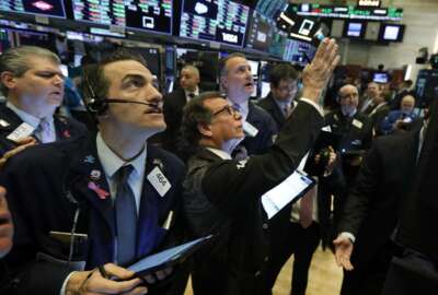 Traders gather at a post on the floor of the New York Stock Exchange, Wednesday, March 4, 2020. Stocks are surging in early trading on Wall Street, led by health care stocks after Joe Biden scored a number of Super Tuesday wins. (AP Photo/Richard Drew)