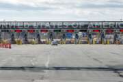 A vehicle approaches the only open lane at the United States border crossing in Lacolle, Quebec, Wednesday, March 18, 2020. The Canada-U.S. border will be closed to non-essential traffic in both directions "by mutual consent," President Donald Trump confirmed Wednesday, as efforts across the continent to contain the widening COVID-19 pandemic continued to upend daily life in North America. (Ryan Remiorz/The Canadian Press via AP)