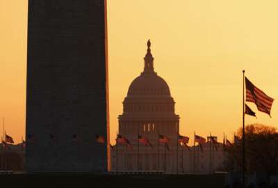 The Washington Monument and the U.S. Capitol are seen in Washington, at sunrise Wednesday, March 18, 2020. The White House has sent Congress an emergency $46 billion spending request for coronavirus-related funding this year. (AP Photo/Carolyn Kaster)