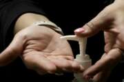 A woman uses hand sanitizer after voting in the presidential primary election at the the Summit View Church of the Nazarene Tuesday, March 10, 2020, in Kansas City, Mo. The polling place served two precincts as voters who were scheduled to vote at a nearby senior living facility were directed to vote at the church after the facility backed out due to coronavirus concerns. (AP Photo/Charlie Riedel)