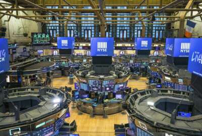 FILE - This photo provided by the New York Stock Exchange shows the unoccupied NYSE trading floor, closed temporarily for the first time in 228 years as a result of coronavirus concerns, Tuesday March 24, 2020. Global stocks and U.S. futures declined Thursday after the U.S. Senate approved a proposed $2.2 trillion virus aid package following a delay over its details and sent the measure to the House of Representatives. (Kearney Ferguson/NYSE via AP, File)