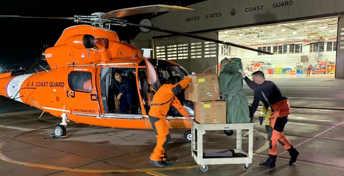 In this Friday, March 6, 2020, image provided by the U.S. Coast Guard, Air Station crew members load personal protective equipment into a helicopter in San Francisco. Thousands of anxious people were confined Saturday to a cruise ship circling in international waters off the San Francisco Bay Area, after 21 passengers and crew members tested positive for the new coronavirus. The Grand Princess was forbidden to dock in San Francisco amid evidence that the vessel had been the breeding ground for a cluster of nearly 20 cases that resulted in at least one death after its previous voyage. (Petty Officer 3rd Class Taylor Bacon/U.S. Coast Guard District 11 via AP)