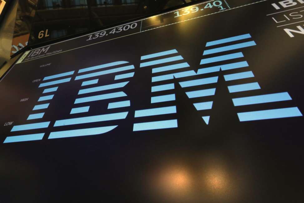 FILE - In this March 18, 2019, photo the logo for IBM appears above a trading post on the floor of the New York Stock Exchange. IBM is offering up its speedy supercomputer to help combat the new coronavirus. The technology company said Sunday, March 22, 2020, that it is working with the White House and the U.S. Department of Energy to make its computing power more accessible to researchers tackling the coronavirus. (AP Photo/Richard Drew, File)