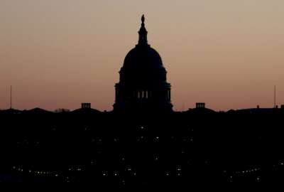 FILE - This Dec. 18, 2019, file photo shows the U.S. Capitol building is seen before sunrise on Capitol Hill in Washington. Congress is shutting the Capitol to the public until April in reaction to the spread of the coronavirus, officials announced Thursday, March 12, 2020, a rare step that underscores the growing gravity with which the government is reacting to the viral outbreak. (AP Photo/Julio Cortez, File)