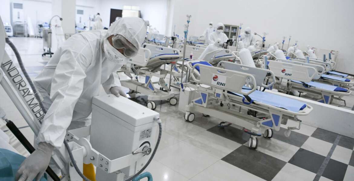 Staff inspect medical equipments at an emergency hospital set up amid the new coronavirus outbreak in Jakarta, Indonesia, Monday, March 23, 2020. Indonesia has changed towers built to house athletes in the 2018 Asian Games to emergency hospitals with a 3,000-bed capacity in the country's hard-hit capital, where new patients have surged in the past week. (Hafidz Mubarak A/Pool Photo via AP)