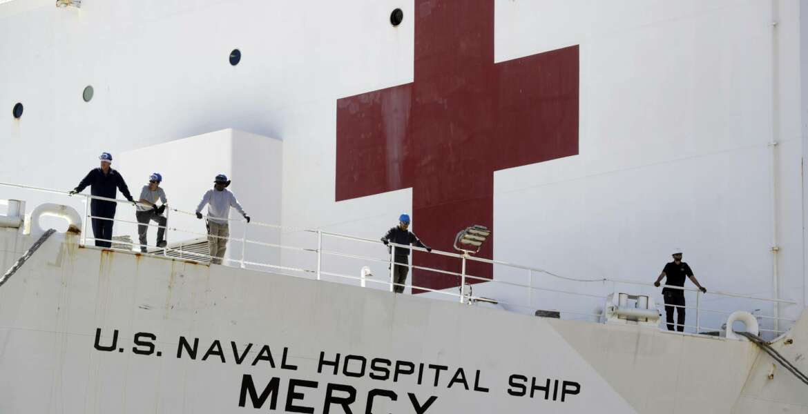 The USNS Mercy hospital ship sits at dock before its departure Monday, March 23, 2020, in San Diego. The Navy hospital ship was preparing to leave San Diego on Tuesday and planned to spend a few days at sea getting its newly formed medical team used to working together before arriving to Los Angeles to help the city free up its hospital beds, in efforts to help combat the coronavirus. (AP Photo/Gregory Bull)