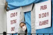 A medical worker sticks her head outside a COVID-19 testing tent set up outside Elmhurst Hospital Center in New York, Saturday, March 28, 2020. The hospital is caring for a high number of coronavirus patients in the city, and New York leads the nation in the number of cases, according to Johns Hopkins University, which is keeping a running tally. (AP Photo/Kathy Willens)