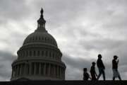 Visitors walk past the U.S. Capitol dome on Capitol Hill in Washington, Thursday, March 12, 2020. Congress is shutting the Capitol and all House and Senate office buildings to the public until April in reaction to the spread of the coronavirus outbreak. (AP Photo/Patrick Semansky)