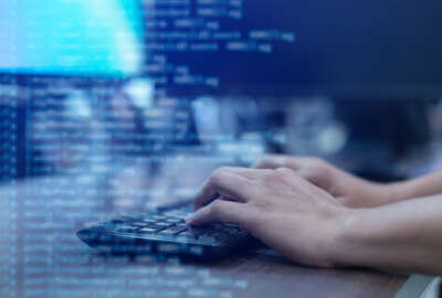 close up programmer man hand typing on keyboard at computer desktop for input coding language to software for fix bug and defect of system in operation room , technology concept