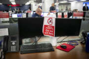 An empty desk shows a sign enforcing social distancing at the Federal Emergency Management Agency headquarters, Monday, April 20, 2020 in Washington, during a visit by Vice President Mike Pence. (Al Drago/The New York Times via AP, Pool)