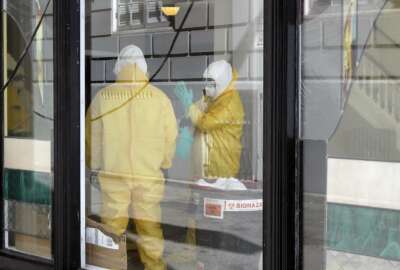 FILE - In this Thursday, April 2, 2020, file photo, workers in hazardous material suits clean inside the Abigail Hotel in San Francisco. The hotel is one of several private hotels San Francisco has contracted with to take vulnerable people who show symptoms or are awaiting test results for the coronavirus. Gov. Gavin Newsom, who made solving the state's homelessness crisis a priority even before the pandemic struck, announced in mid-March his administration was negotiating with 900 hotels to house the homeless. Two weeks ago he announced Project Roomkey, a program in which the Federal Emergency Management Agency will pay 75% of costs associated with housing some homeless, including people who test positive or may have been exposed to the virus, and older homeless people and those with underlying health conditions. (AP Photo/Jeff Chiu, File)