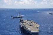 FILE -- In this July 26, 2018, file photo provided by the U.S. Navy, the aircraft carrier USS Carl Vinson participates in a group sail during the Rim of the Pacific exercise off the coast of Hawaii. Hawaii's governor says he will ask the U.S. military to postpone the world's largest maritime exercises because of the coronavirus pandemic. (Petty Officer 1st Class Arthurgwain L. Marquez/U.S. Navy via AP, File)