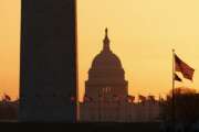 FILE - In this March 18, 2020, file photo, the Washington Monument and the U.S. Capitol are seen in Washington, at sunrise. Congress is considering ways to govern from afar during the coronavirus pandemic. Lawmakers are talking this week about whether it's possible to conduct virtual committee meetings, particularly to oversee how the $2.2 trillion stimulus money is being spent. And they're considering ways to pass virus-related legislation without requiring every lawmaker to be present. (AP Photo/Carolyn Kaster, File)