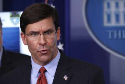 FILE - In this April 1, 2020, file photo, Defense Secretary Mark Esper speaks about the coronavirus in the James Brady Press Briefing Room of the White House in Washington. The U.S. military is bracing for a months-long struggle against the coronavirus. It is looking for novel ways to maintain a defensive crouch that protects the health of troops without breaking their morale. (AP Photo/Alex Brandon, File)