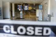 FILE - In this April 3, 2020, file photo, the seats and aisles are empty as seen through the window of the closed Penndot Drivers License Center in Butler, Pa. Some owners who got their money said they're now feeling more confident about being able to retain their employees after businesses closed due to the coronavirus outbreak. (AP Photo/Keith Srakocic, File)