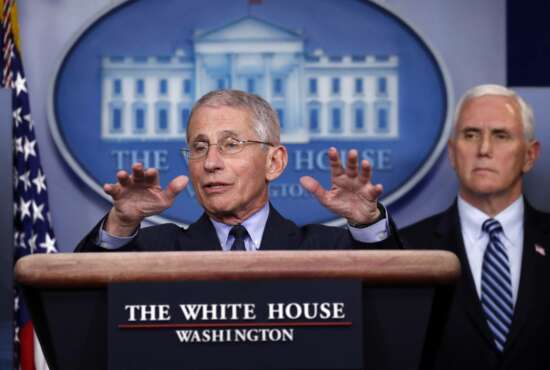 Dr. Anthony Fauci, director of the National Institute of Allergy and Infectious Diseases, speaks about the coronavirus in the James Brady Press Briefing Room of the White House, Wednesday, April 1, 2020, in Washington, as Vice President Mike Pence listens. (AP Photo/Alex Brandon)