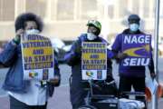 Clarence Shields, center, an Army veteran, pickets with a small group of activists from the American Federation of Government Employees local 424 and the National Association of Government Employees local R3-19 outside the Baltimore VA Medical Center, Wednesday, April 22, 2020, in Baltimore. The Department of Veterans Affairs is struggling with shortages of workers at its health care facilities as it cares for veterans infected with the novel coronavirus. (AP Photo/Julio Cortez)