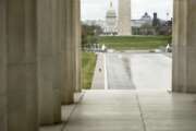 FILE - In this March 31, 2020, file photo the Dome of the U.S. Capitol and the Washington Monument are visible as a lone woman runs along the Reflecting Pool on the National Mall in Washington. The nation's capital, like most of the nation itself, is largely shuttered. (AP Photo/Andrew Harnik, File)