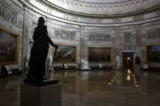 FILE - In this April 9, 2020, file photo statue of President George Washington looks over an empty Capitol Rotunda on Capitol Hill in Washington. The nation's capital, like most of the nation itself, is largely shuttered. (AP Photo/Patrick Semansky, File)