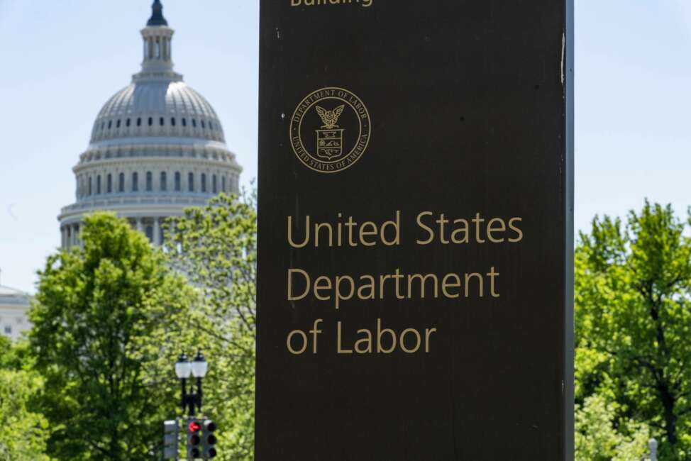 In this May 7, 2020, photo, the entrance to the Labor Department is seen near the Capitol in Washington. The record unemployment rate reflects a nation ravaged by the coronavirus pandemic, the economic devastation upending the presidential campaign and forcing President Donald Trump to overcome historic headwinds to win a second term.  (AP Photo/J. Scott Applewhite)