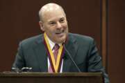 In this March 1, 2017 photo, Elon Trustee Louis DeJoy is honored with Elon's Medal for Entrepreneurial Leadership in Elon. N.C. DeJoy, a Republican fundraiser and prolific political donor from North Carolina, will be the next postmaster general. DeJoy of Greensboro, a close ally of President Donald Trump, was the unanimous pick of the U.S. Postal Service's Board of Governors, which made the announcement. 
(Kim Walker/Elon University via AP)