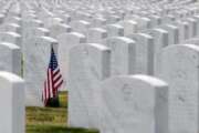 this May 22, 2020 photo, a U.S. flag decorates a veteran's grave at Alabama National Cemetery in Montevallo, Ala. Because of the coronavirus pandemic, the government has banned public ceremonies and the mass placement of flags on graves at the country's 142 national cemeteries. With almost 4.9 million people interred in the cemeteries, thousands would attend memorial events and help mark graves with flags during a typical Memorial Day weekend. (AP Photo/Jay Reeves)