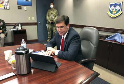 Defense Secretary Mark Esper speaks by video teleconference from U.S. Northern Command in Colorado Springs, Colo., on Thursday, May 7, 2020, with military medical specialists at civilian hospitals in New York and Connecticut. (AP Photo/Robert Burns)
