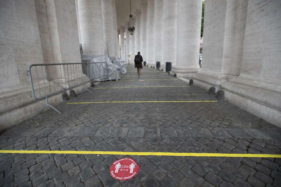 Indications of social distancing to prevent the spread of COVID-19 are placed under the colonnade designed by 16th century Italian sculptor and architect Gian Lorenzo Bernini, in St. Peter's Square at the Vatican in the day of the reopening of St. Peter's Basilica, Monday, May 18, 2020. Italy is slowly lifting sanitary restrictions after a two-month coronavirus lockdown. (AP Photo/Alessandra Tarantino)