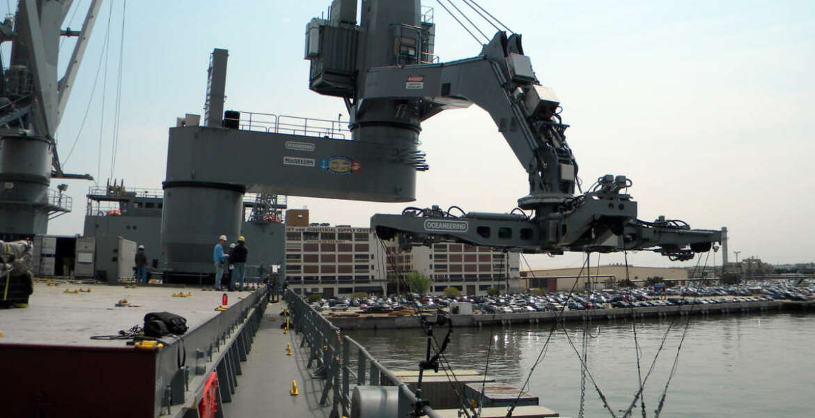 The Office of Naval Research tests their Large Vessel Interface Lift-on/Lift-off crane at Naval Station Norfolk. The demonstrator crane, which has been temporarily installed on the Maritime Administration ship SS Flickertail State, uses motion-sensing technology to control standard 20-foot containers in all six degrees of freedom. 