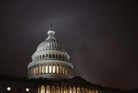 FILE - In this Dec. 9, 2019, file photo mist rolls over the U.S. Capitol dome on Capitol Hill in Washington.  The federal government recorded a budget deficit of $1.88 trillion for the first eight months of 2020, larger than even any annual shortfalls in U.S. history. The sea of red ink grew as government spending shot up to deal with the coronavirus pandemic and tax revenue shrank when millions lost their jobs. (AP Photo/Patrick Semansky, File)