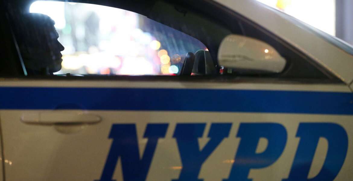FILE - In this Dec. 31, 2015, file photo, a New York City police officer sits in a cruiser at a checkpoint surrounding Times Square during New Year's Eve celebrations in New York. The vast majority of complaints about New York City police officers' mistreatment of youths stemmed from encounters with black and Hispanic children, according to a new study by the city’s police watchdog agency. Nearly two-thirds of youth complaints to the Civilian Complaint Review Board involved children of color, the report says, including some “stopped for seemingly innocuous activities such as playing, high-fiving, running, carrying backpacks, and jaywalking.