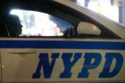 FILE - In this Dec. 31, 2015, file photo, a New York City police officer sits in a cruiser at a checkpoint surrounding Times Square during New Year's Eve celebrations in New York. The vast majority of complaints about New York City police officers' mistreatment of youths stemmed from encounters with black and Hispanic children, according to a new study by the city’s police watchdog agency. Nearly two-thirds of youth complaints to the Civilian Complaint Review Board involved children of color, the report says, including some “stopped for seemingly innocuous activities such as playing, high-fiving, running, carrying backpacks, and jaywalking." (AP Photo/Julio Cortez, File)