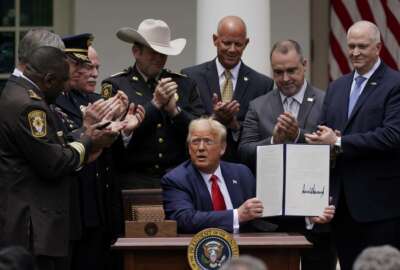 Law enforcement officials applaud after President Donald Trump signed an executive order on police reform, in the Rose Garden of the White House, Tuesday, June 16, 2020, in Washington. (AP Photo/Evan Vucci)