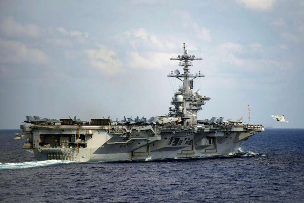 In this March 18, 2020, photo provided by the U.S. Navy, an F/A-18F Super Hornet launches from the flight deck of the aircraft carrier USS Theodore Roosevelt (CVN 71) in the western North Pacific Ocean. In a stunning reversal, the Navy has upheld the firing of Crozier, the aircraft carrier captain who urged faster action to protect his crew from a coronavirus outbreak, according to a U.S. official. (Mass Communication Specialist 3rd Class Nicholas V. Huynh/U.S. Navy via AP))