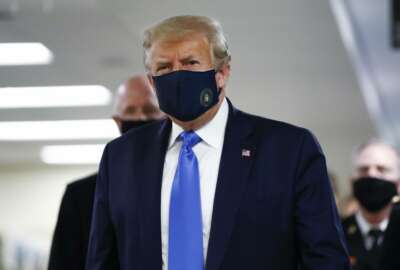 President Donald Trump wears a mask as he walks down the hallway during his visit to Walter Reed National Military Medical Center in Bethesda, Md., Saturday, July 11, 2020. (AP Photo/Patrick Semansky)