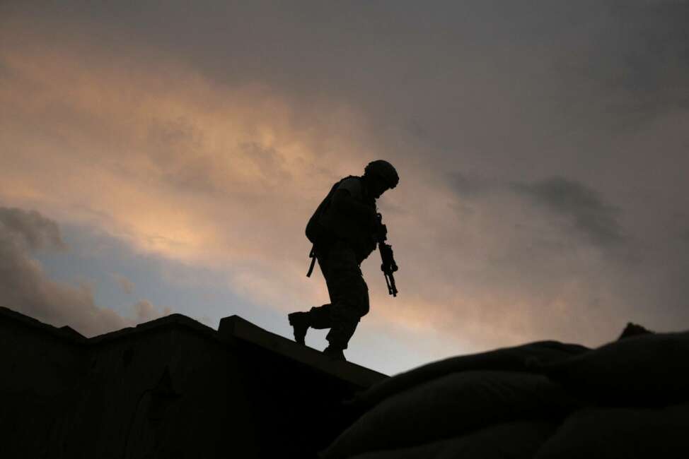 FILE -  In this Sept. 18, 2009, file, photo, A soldier from the U.S. Army's 118th Military Police Co., based at Fort Bragg, N.C., respond to shots fired at a combat outpost in the Jalrez Valley in Afghanistan's Wardak Province.  Moscow and Washington are intertwined in a complex and bloody history in Afghanistan, with both suffering thousands of dead and wounded in conflicts lasting for years. Now both superpowers are linked again over Afghanistan, with intelligence reports indicating Russia secretly offered bounties to the Taliban to kill American troops there. But analysts suggest that the two adversaries actually have more in common, especially when it comes to what they want to see in a postwar Afghanistan: a stable country that does not serve as a base for extremists to export terrorism. Both countries also are aligned in their opposition to militants from the Islamic State group.(AP Photo/Maya Alleruzzo, File)